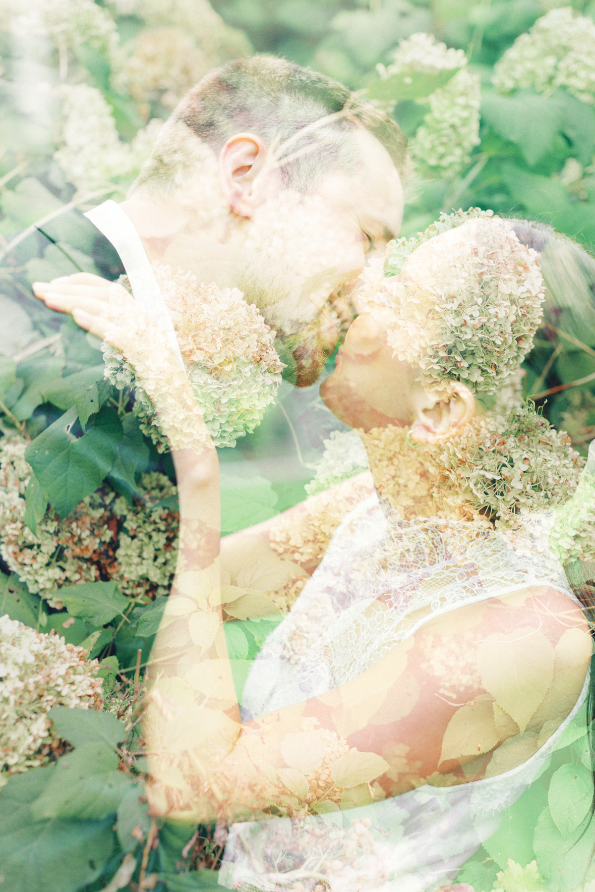 Double exposure with couple kissing and flowers over top