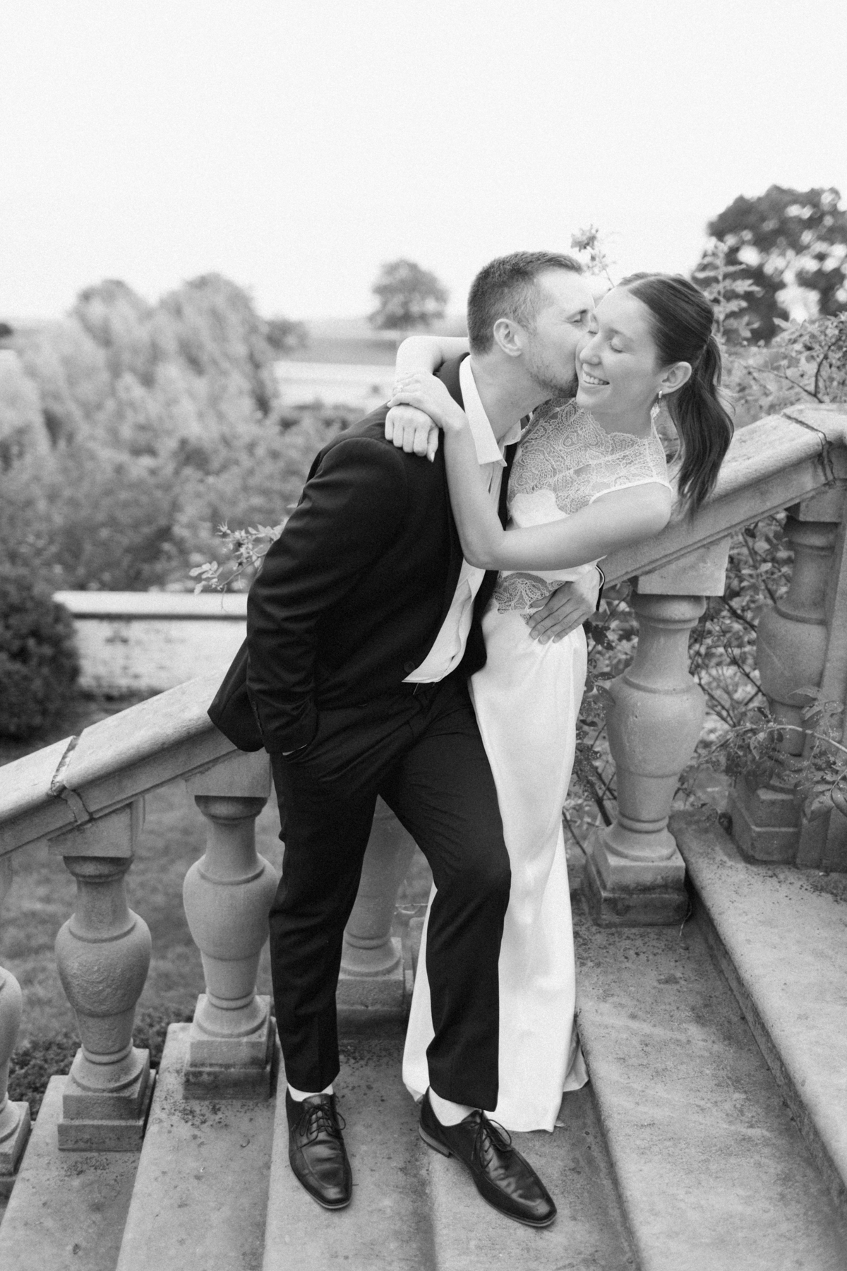 Black-and-white photo of couple on staircase