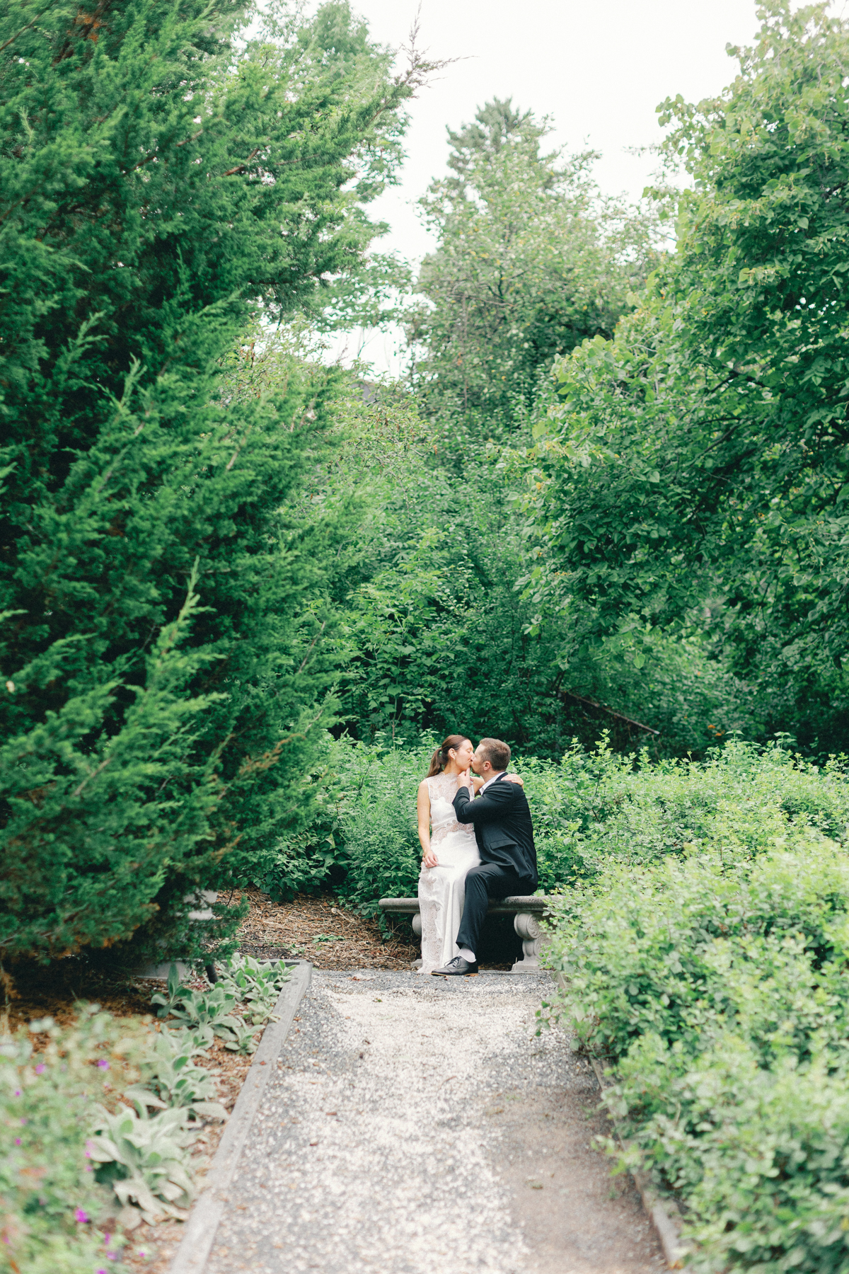 Couple sitting on bench garden kissing kiss