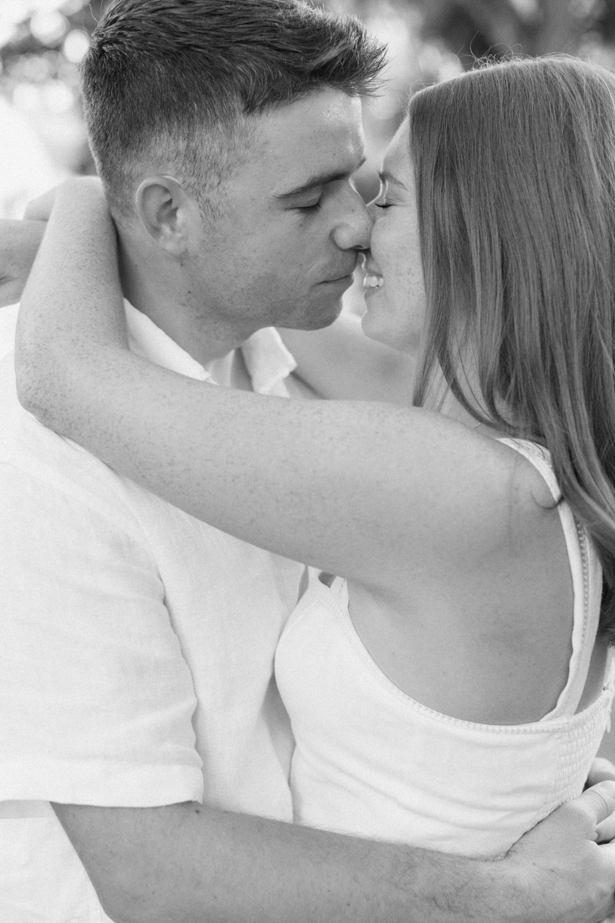 Black-and-white photo of couple, almost kissing