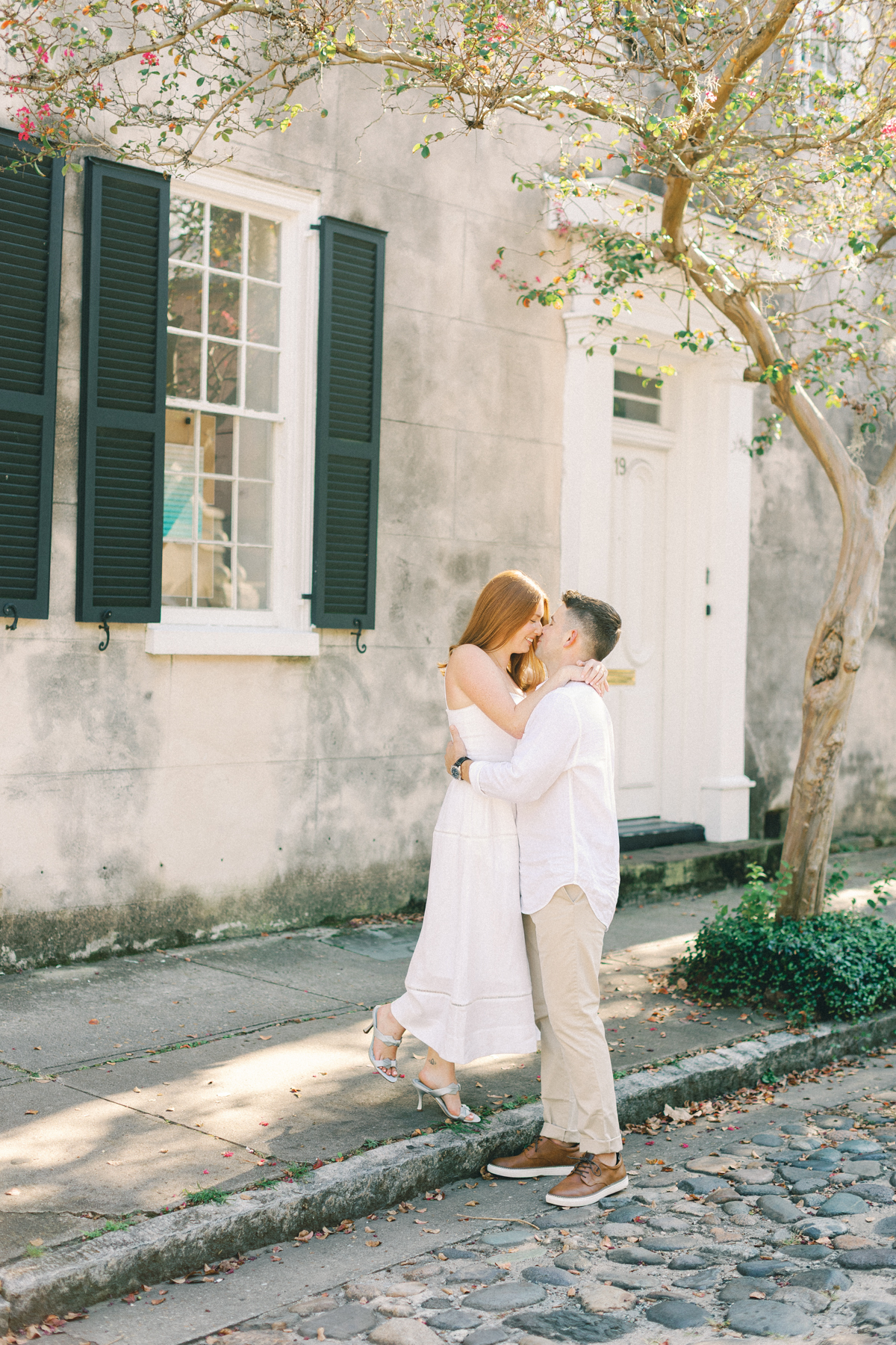 Couple kissing on sidewalk