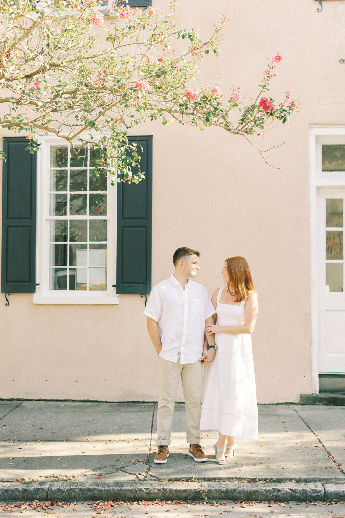Couple looking at each other on sidewalk