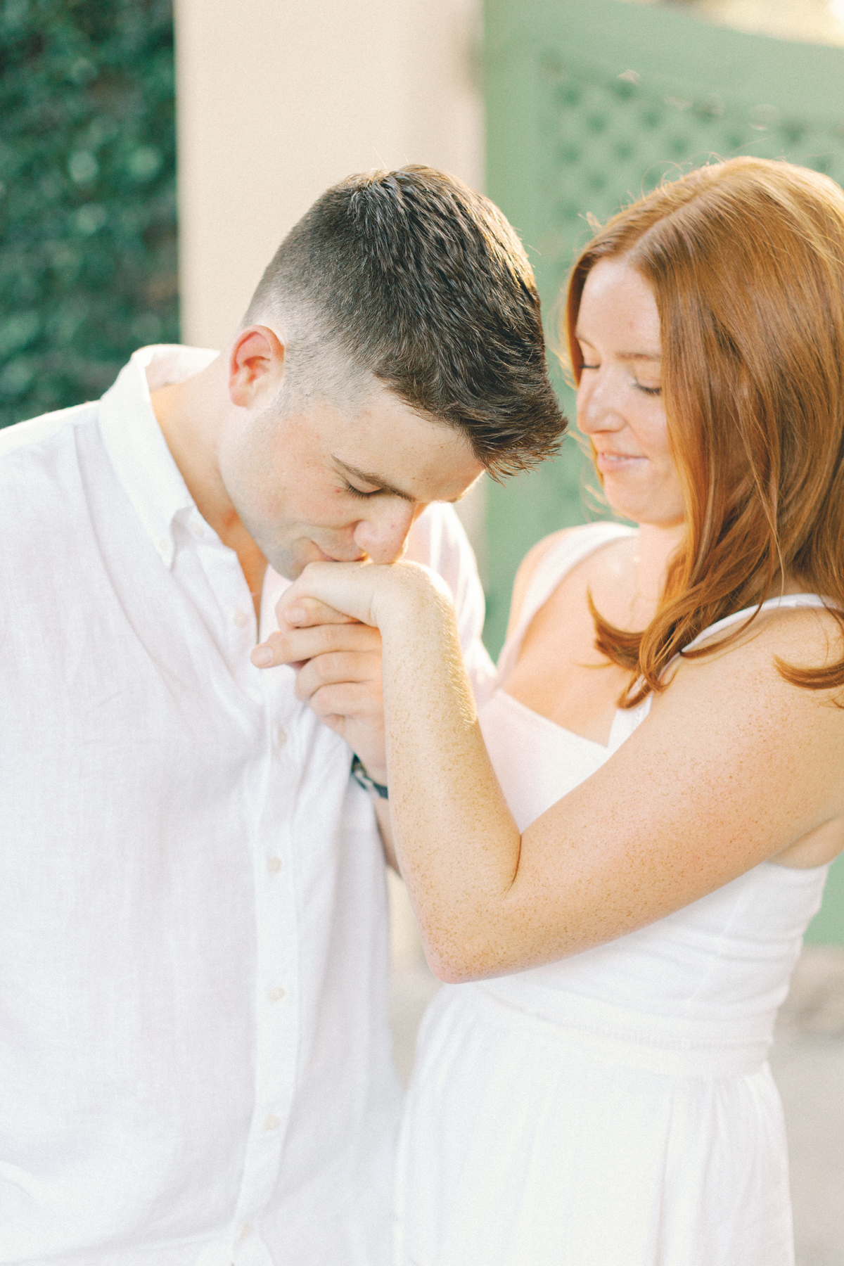 Him kissing her hand
