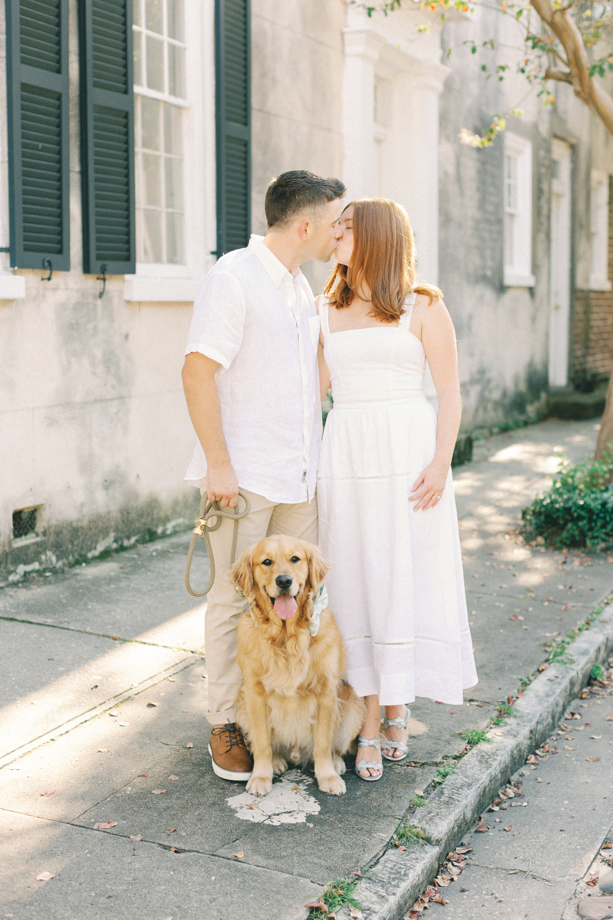 Couple kissing with a dog