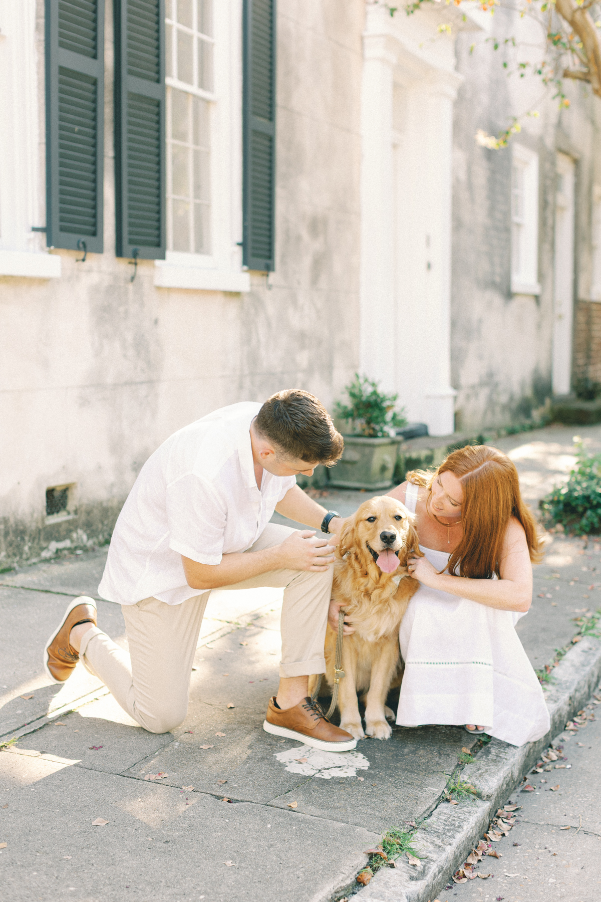 Couple snuggling their dog