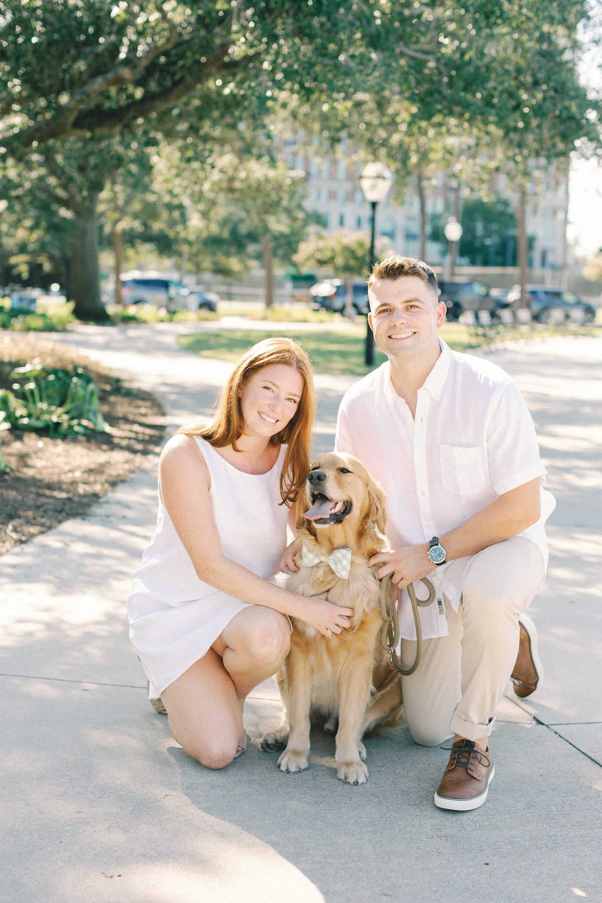 Couple looking at camera with her dog