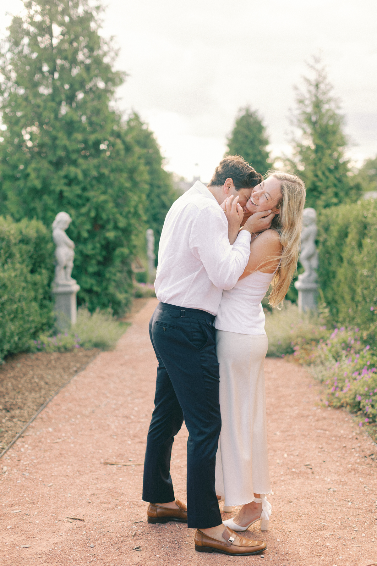 Him kissing her cheek, laughing