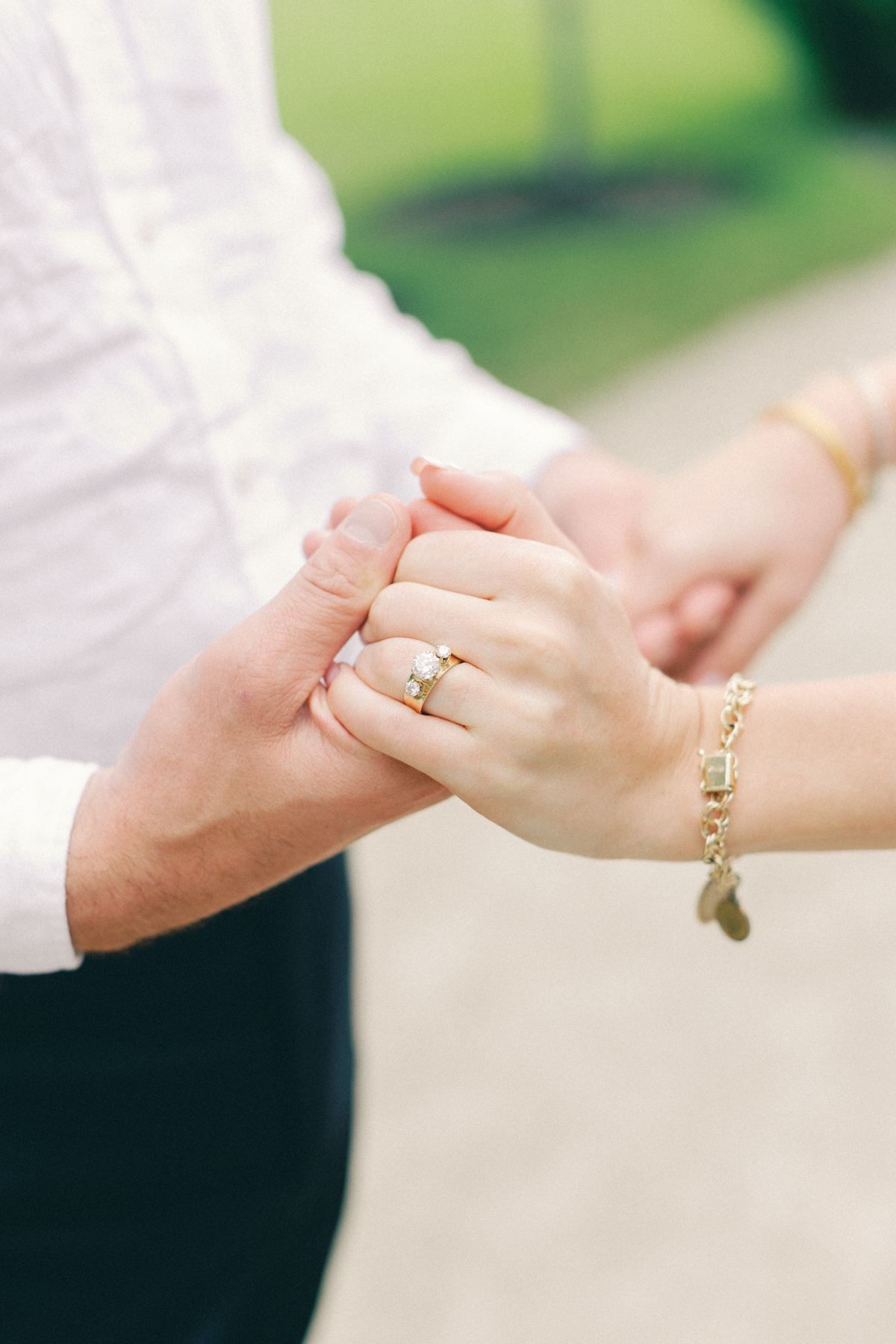 Him holding her hand with the ring and focus