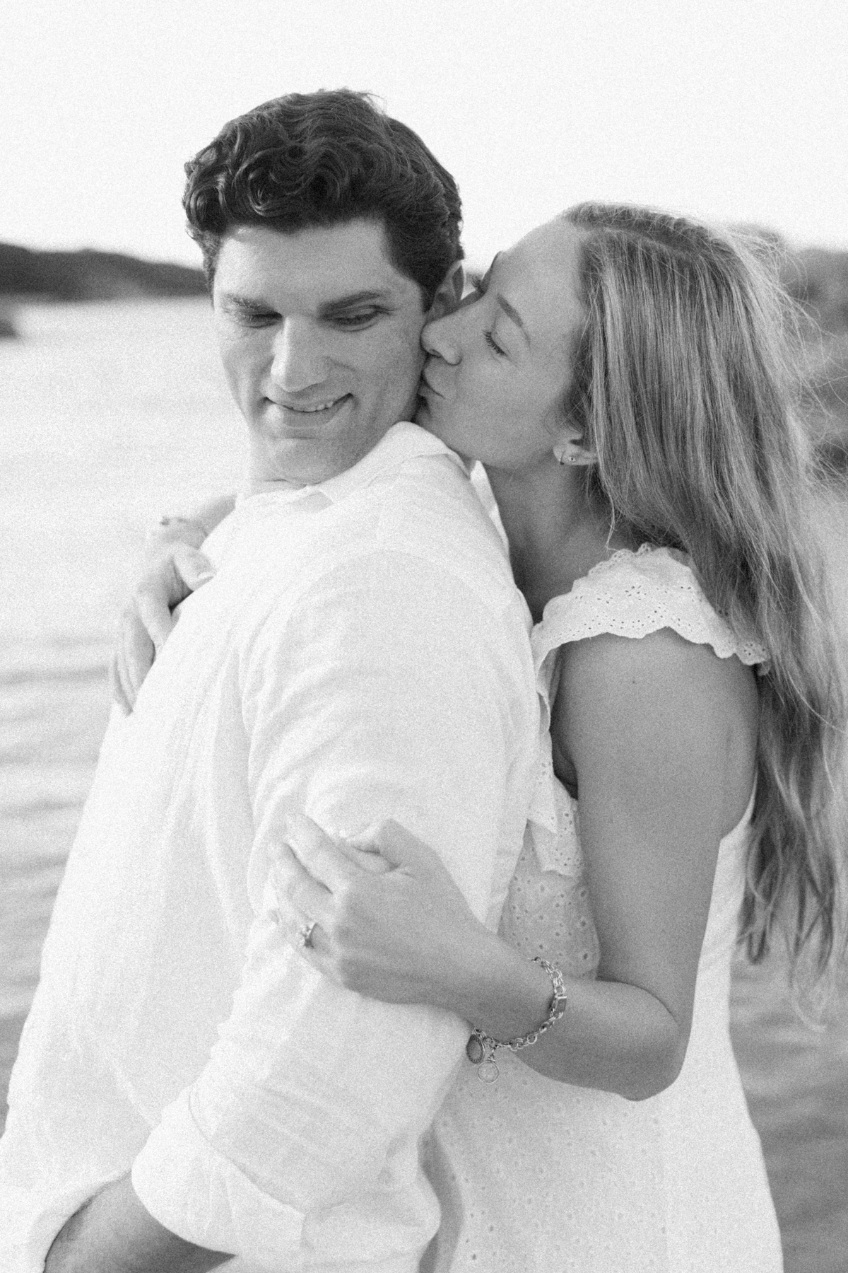 Her kissing his cheek black-and-white