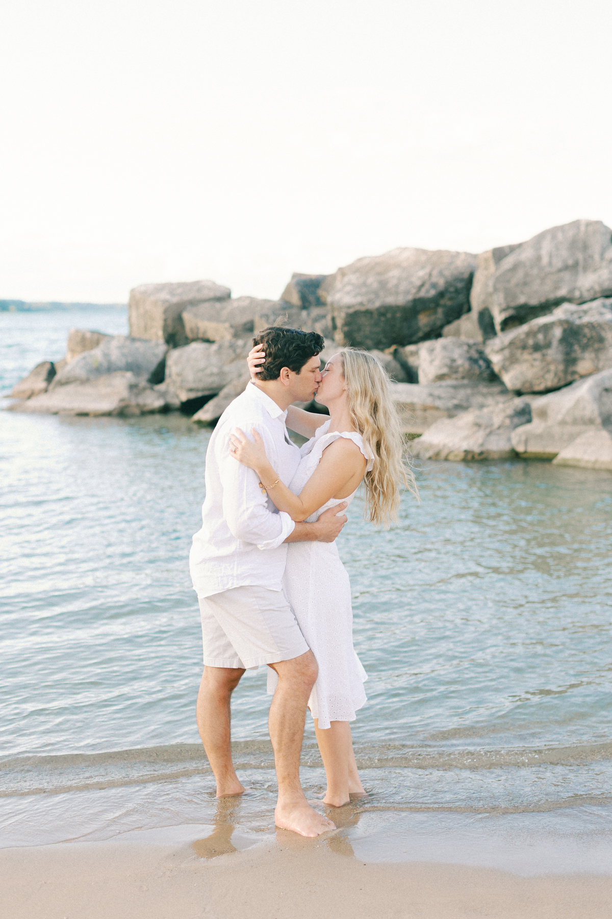 Couple kissing in front of rocks
