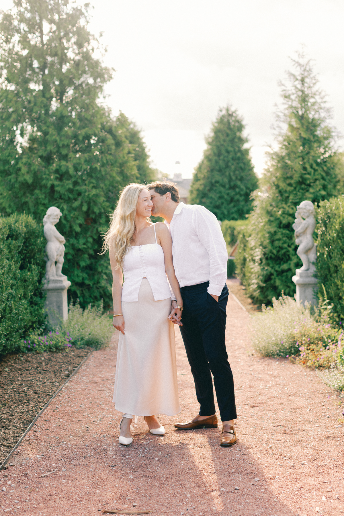 groom kissing her on the cheek