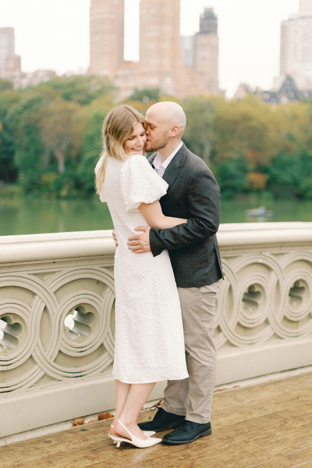 Couple snuggled up on bridge
