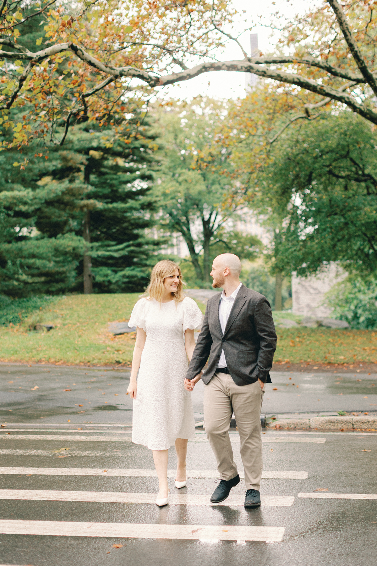 Couple walking towards camera crossing the street