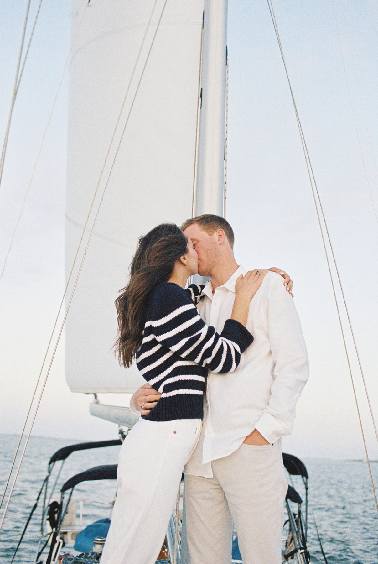 couple kissing on sailboat