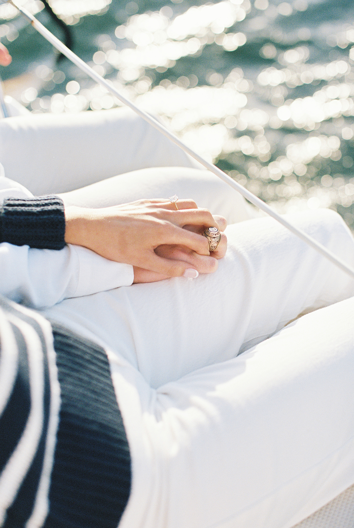 couple holding hands on sailboat