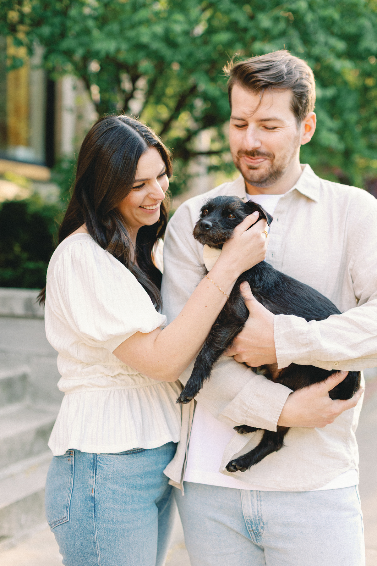 Couple cuddling their dog