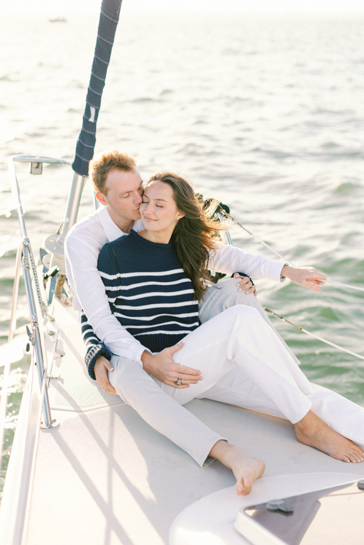 Couple on sailboat snuggling