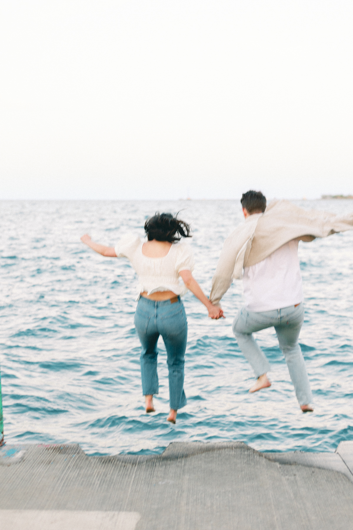 Couple jumping in the water