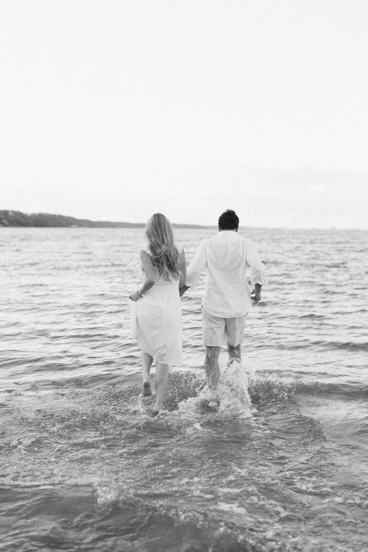 Couple plunging into water black-and-white