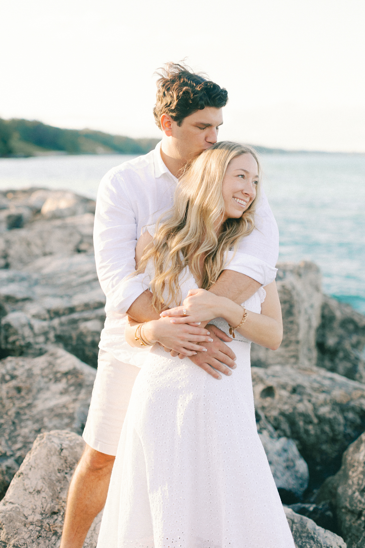 Couple snuggled up on rocks