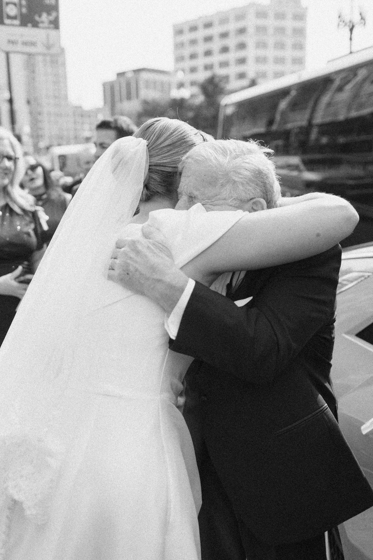 Bride and grandpa hugging crying