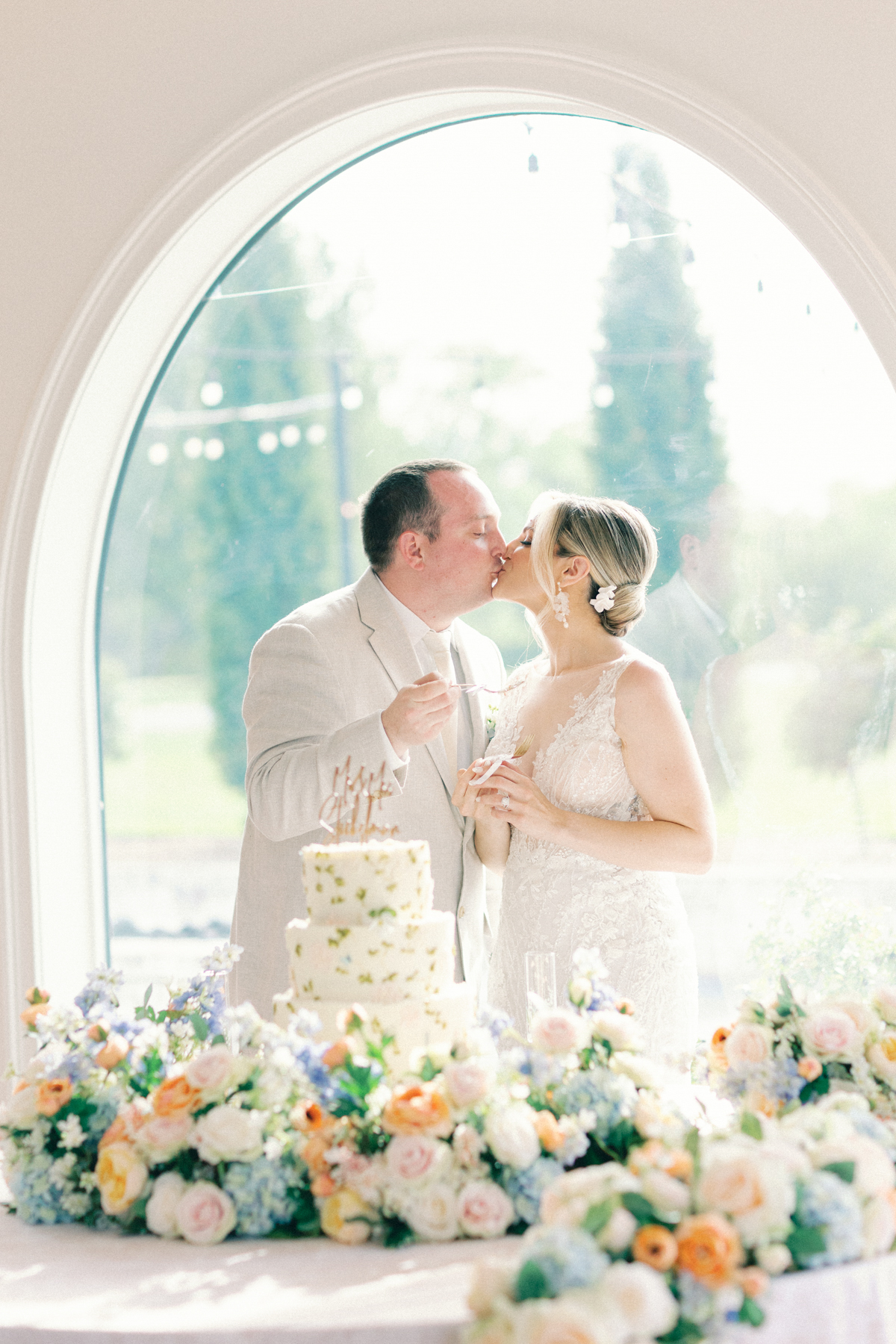 Bride and groom, cake cutting kiss