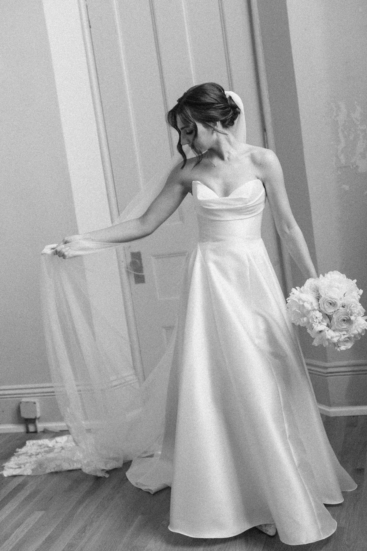 Bridal portrait playing with veil