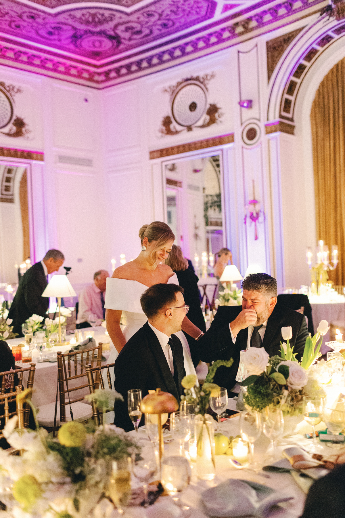 Bride and (groom) interacting with guest