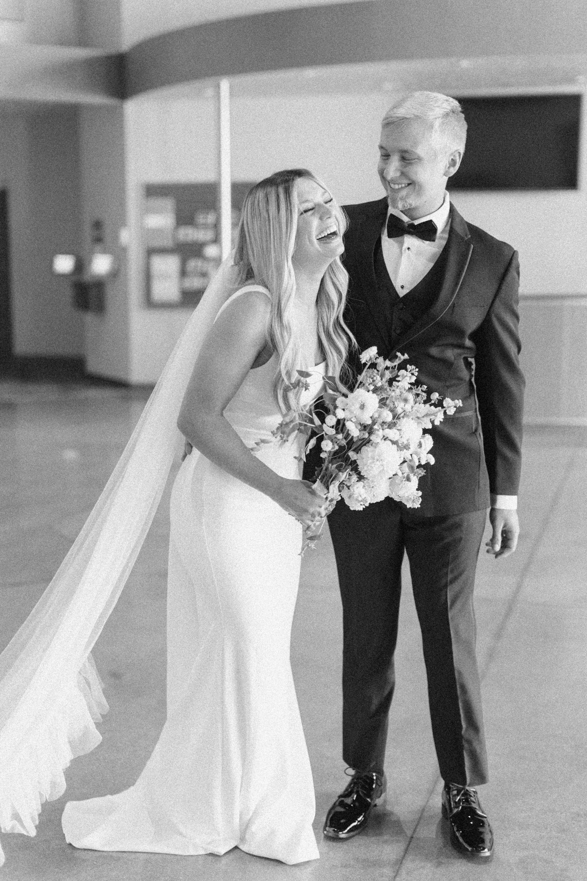 Bride and (groom) laughing