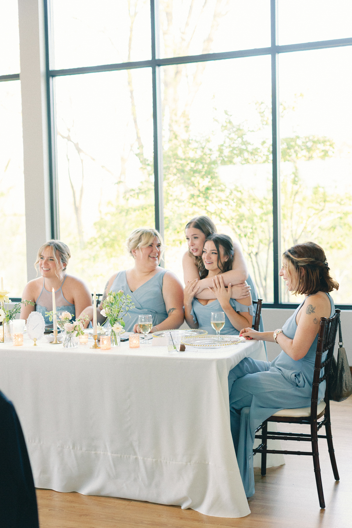 Bridesmaids laughing during speeches