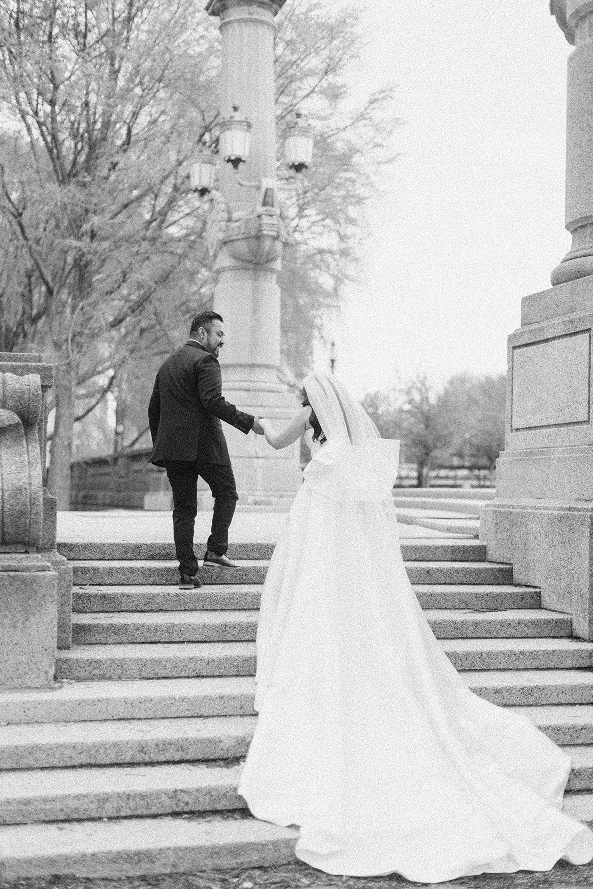 bride and groom walking up stairs