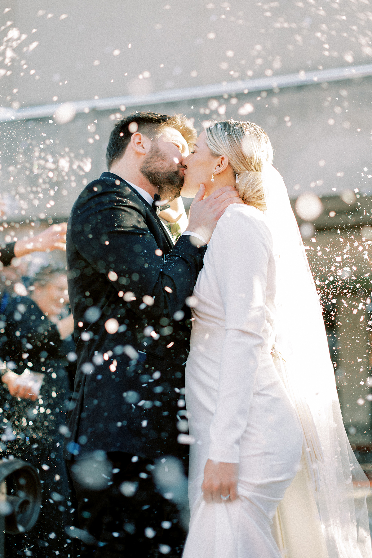 bride and groom kissing with snow
