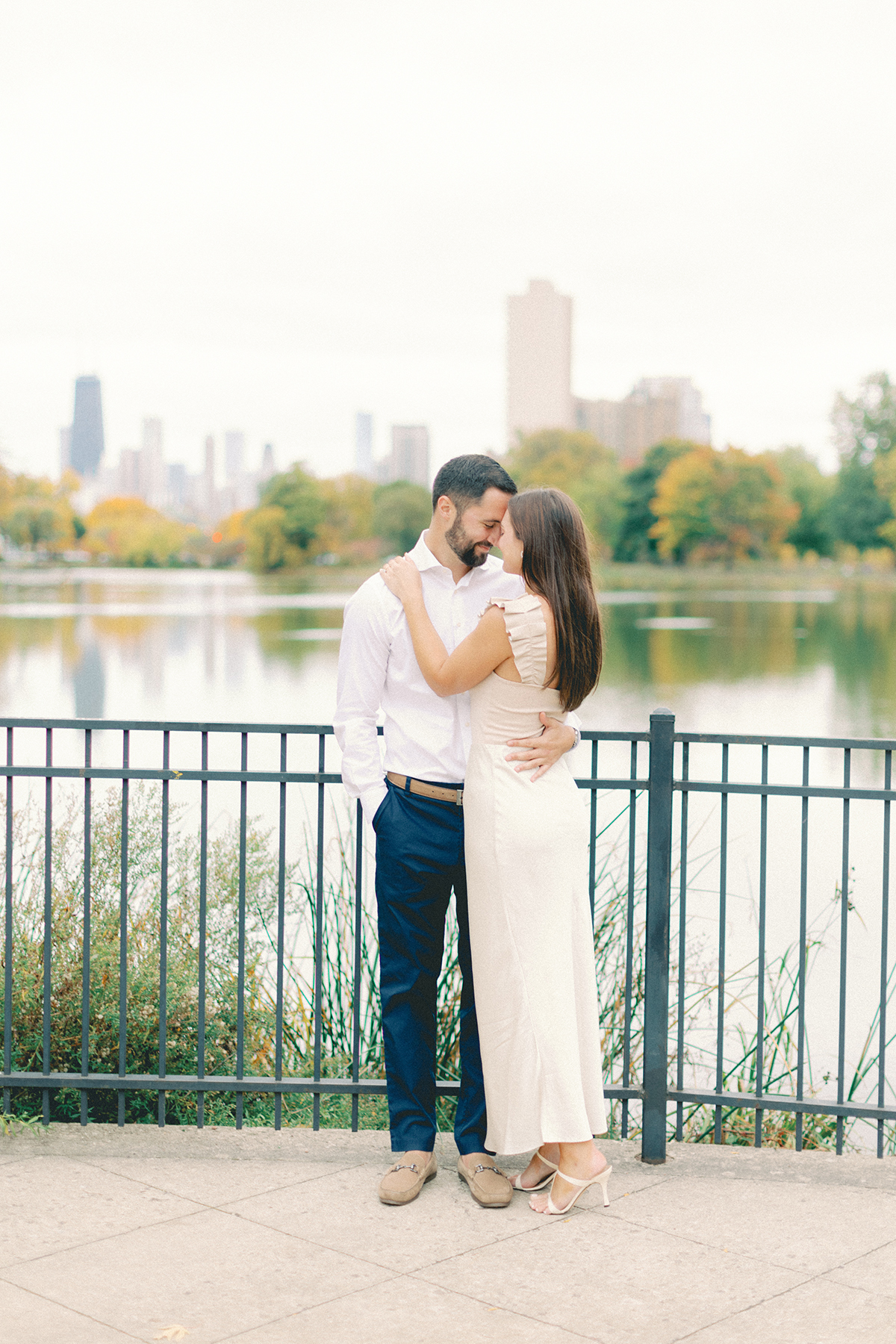 couple in park with chicago behind