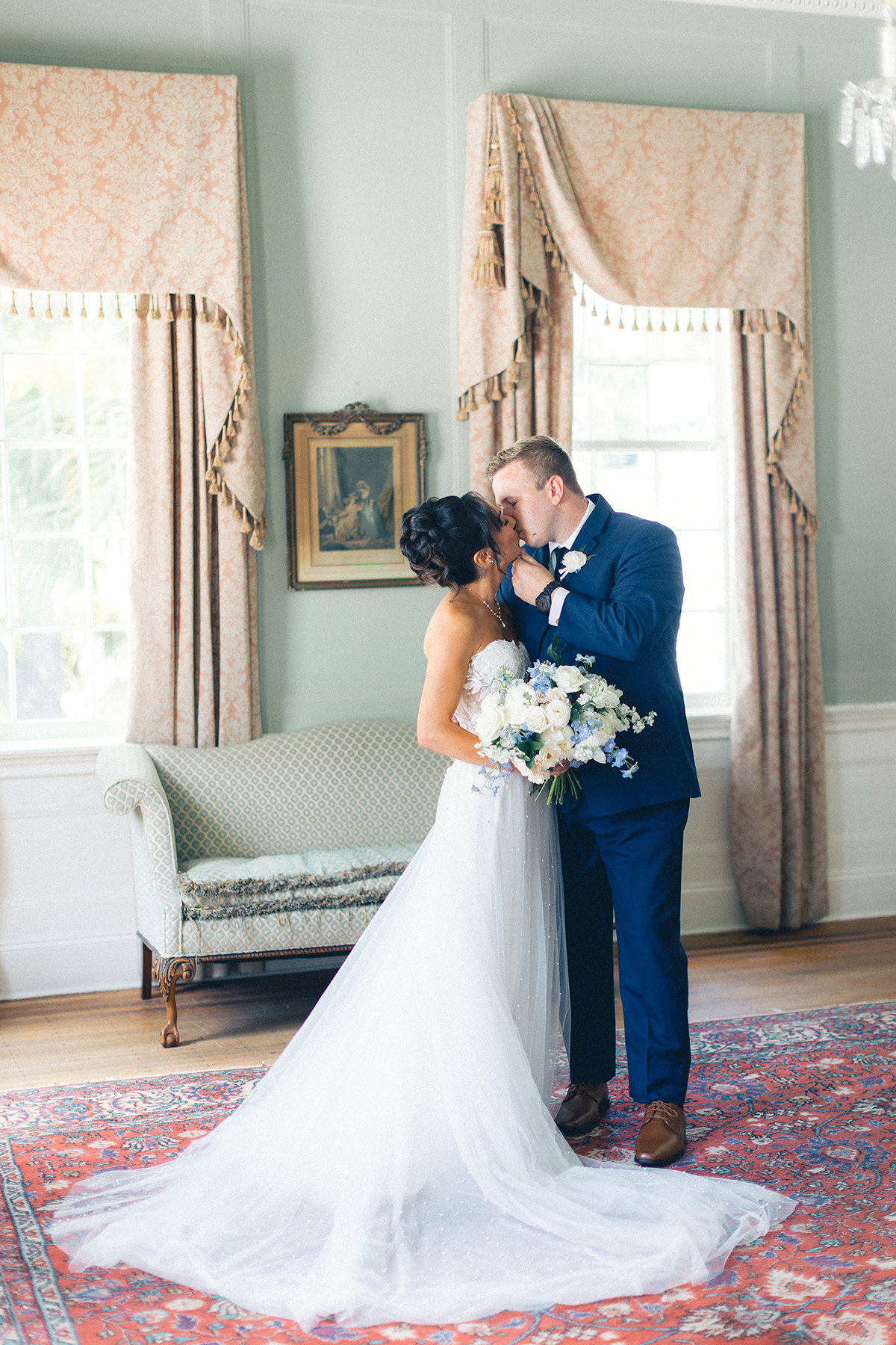 bride and groom kissing inside room