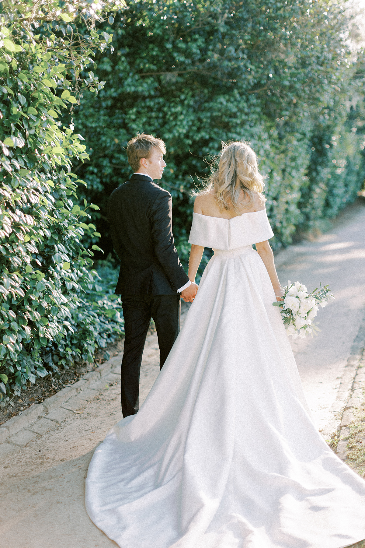 Couple holding hands walking away