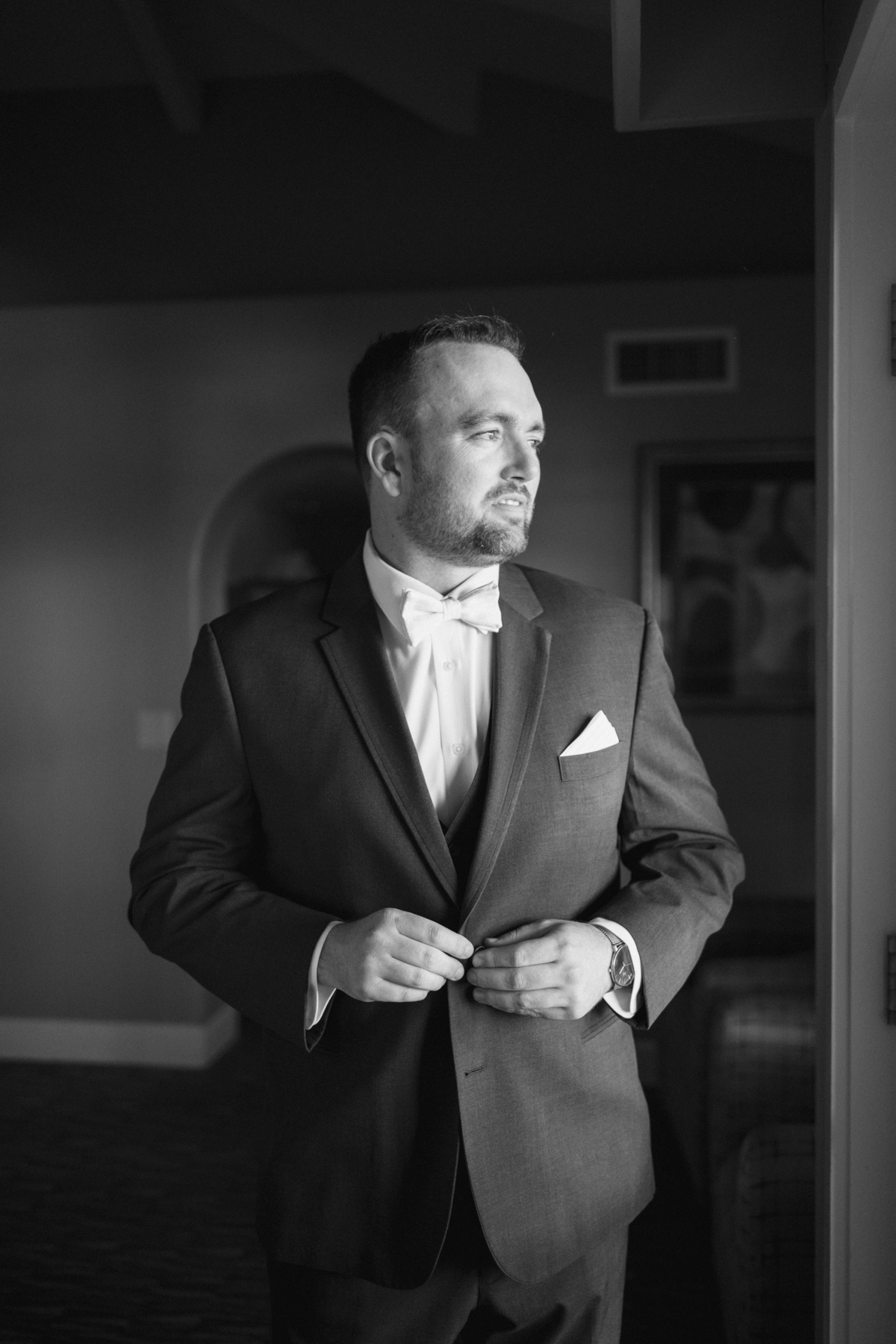 (groom) putting on coat