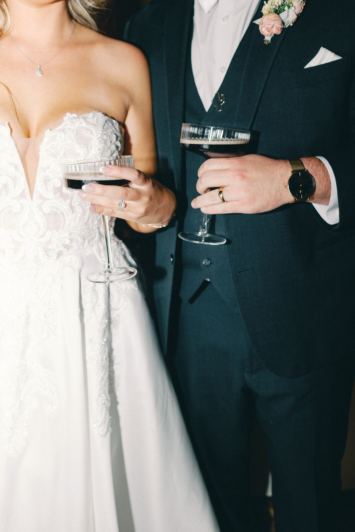 Bride and groom holding martinis