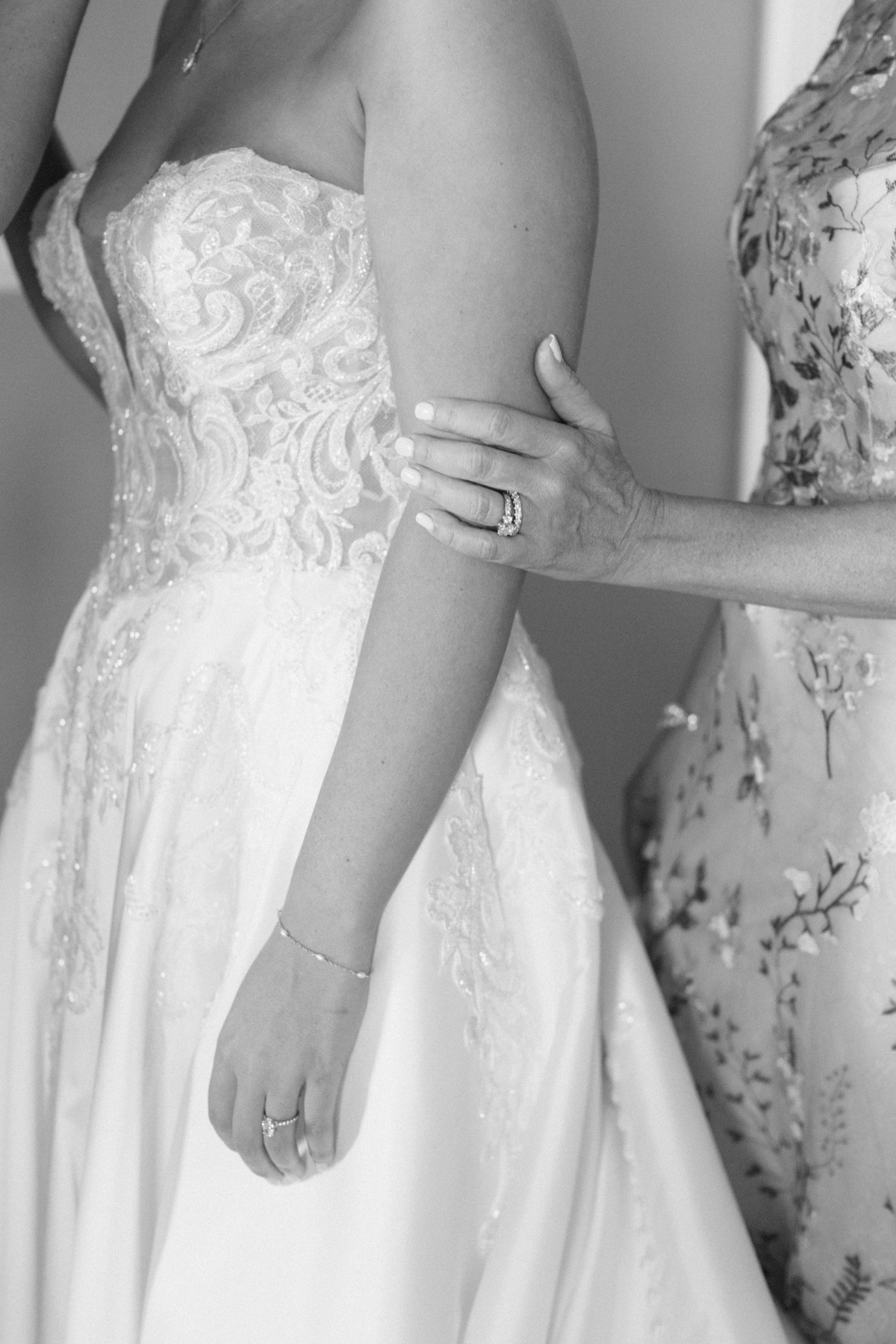 Mom's hand on bride's arm