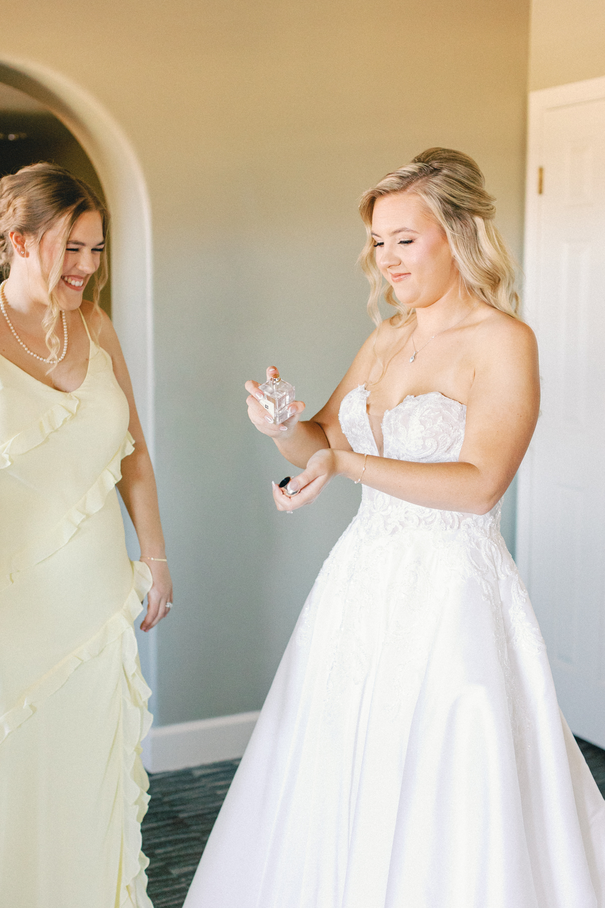 Bride spraying perfume