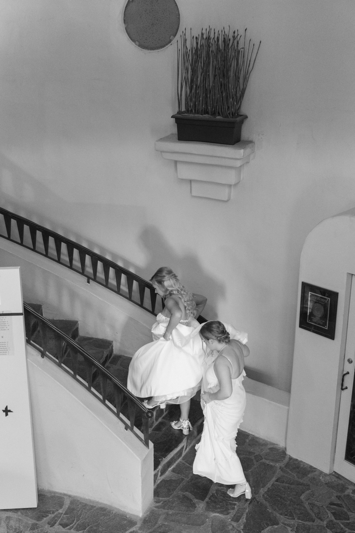 Made of honor and bride walking upstairs