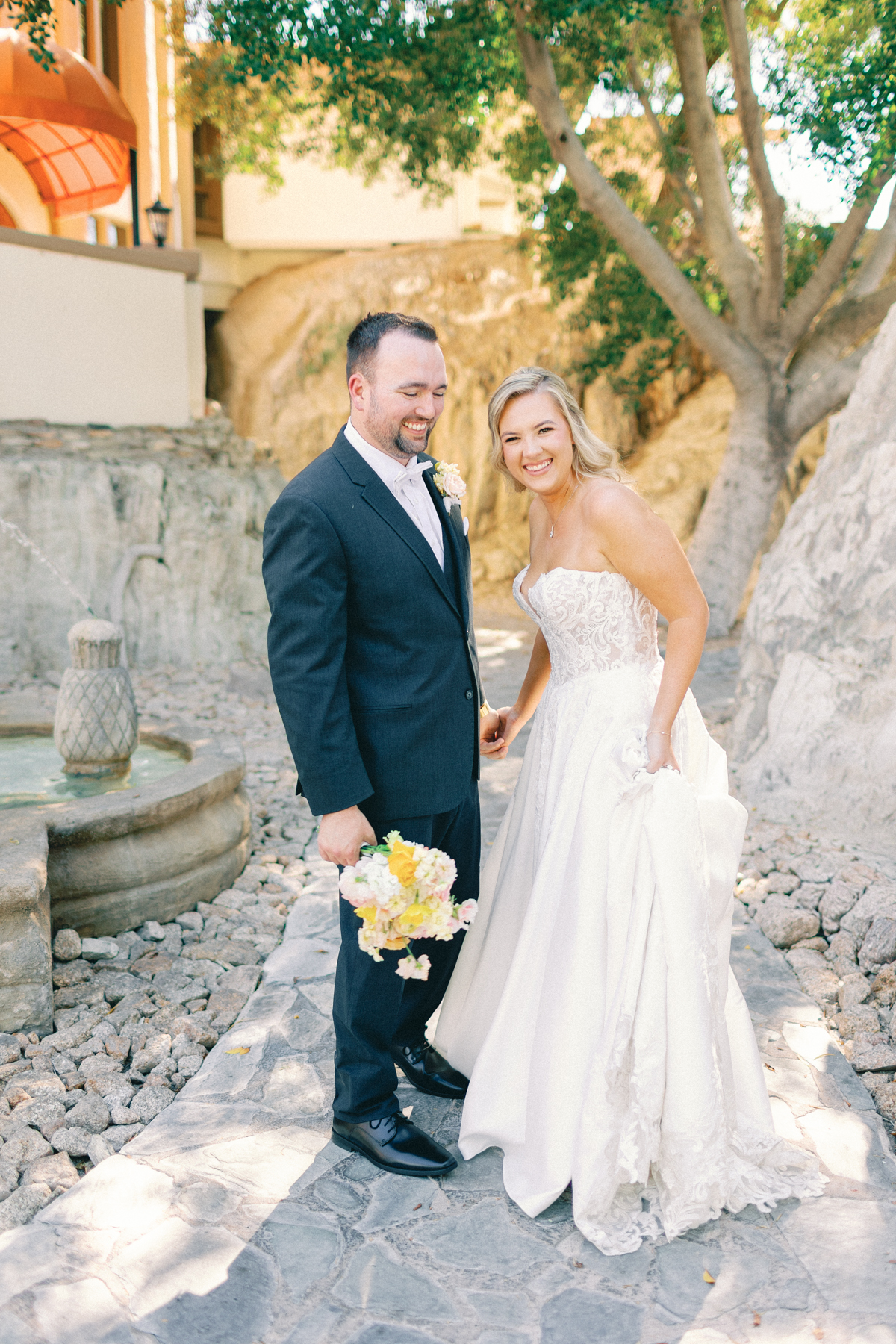 Bride and groom, laughing at camera