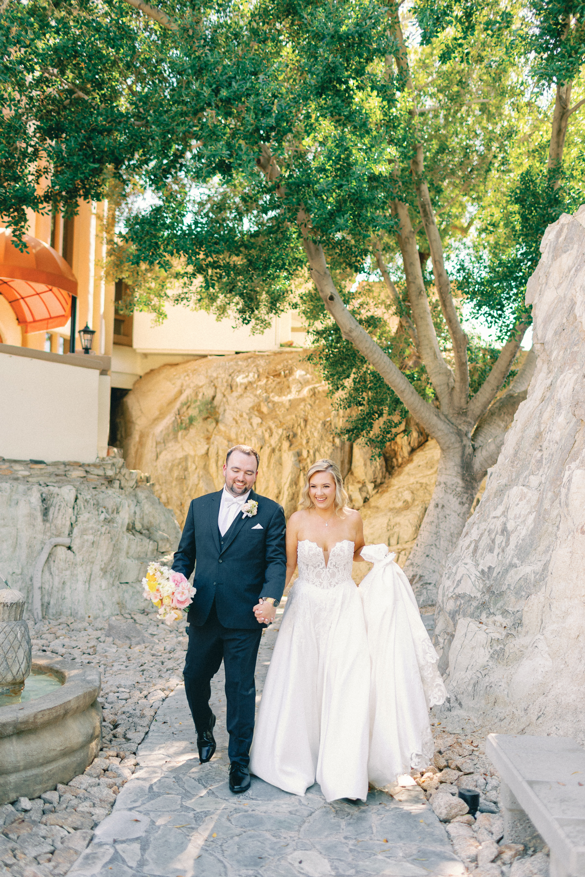Bride and (groom) walking towards camera