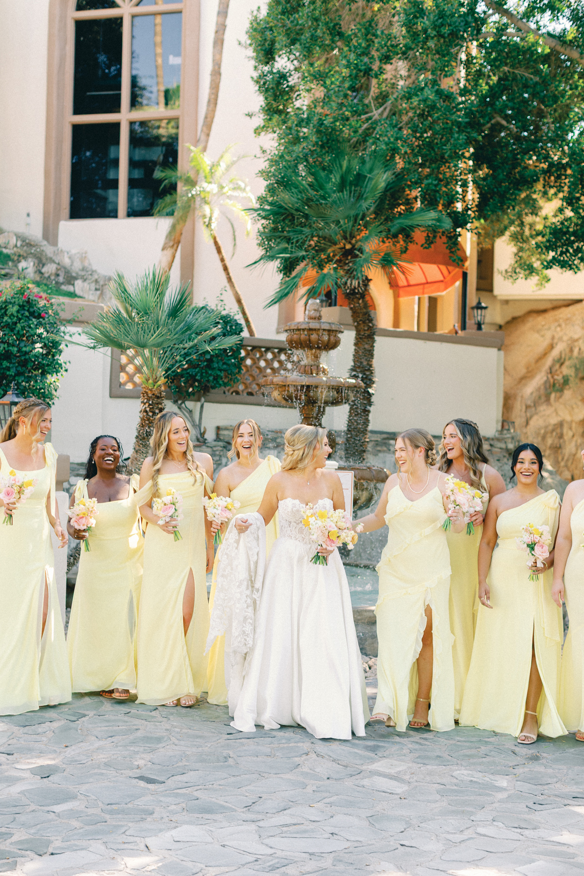 Bridesmaids and bride laughing and walking
