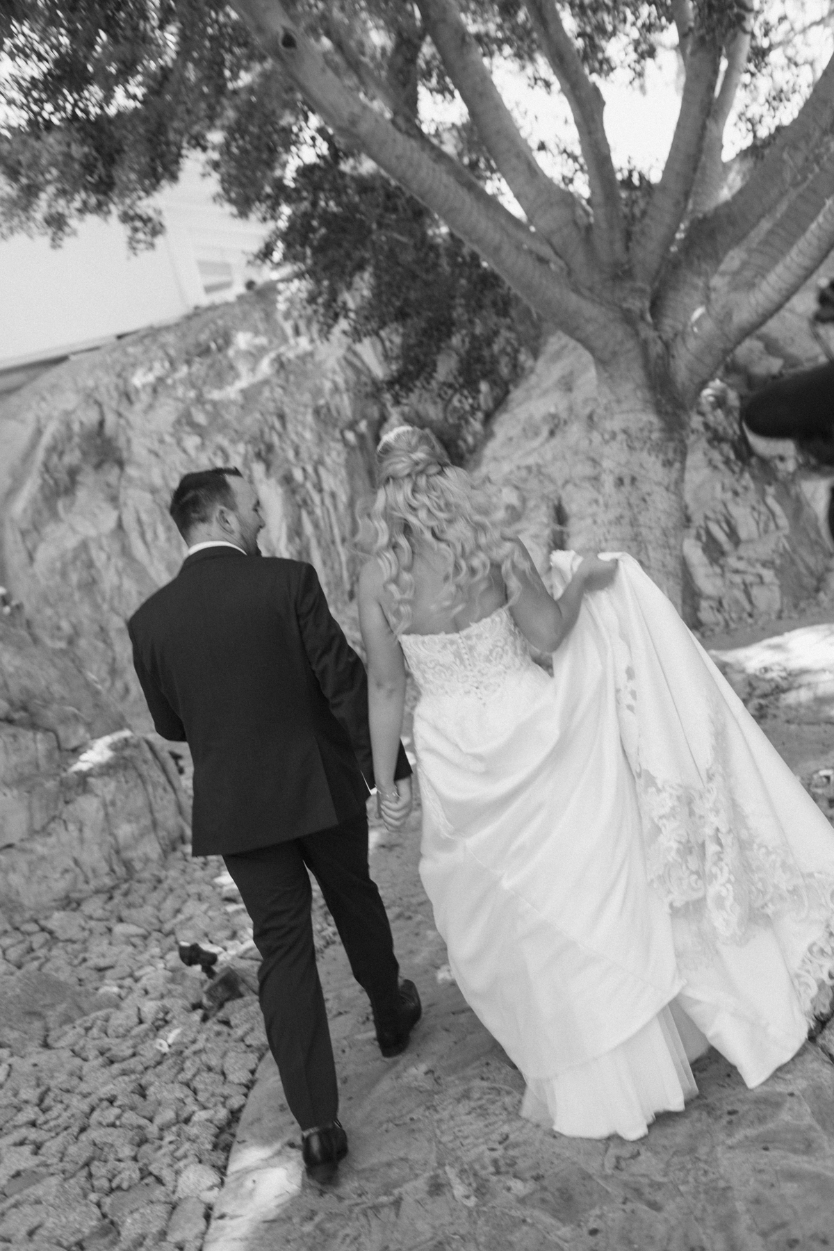 Blurry photo of bride and (groom) walking away