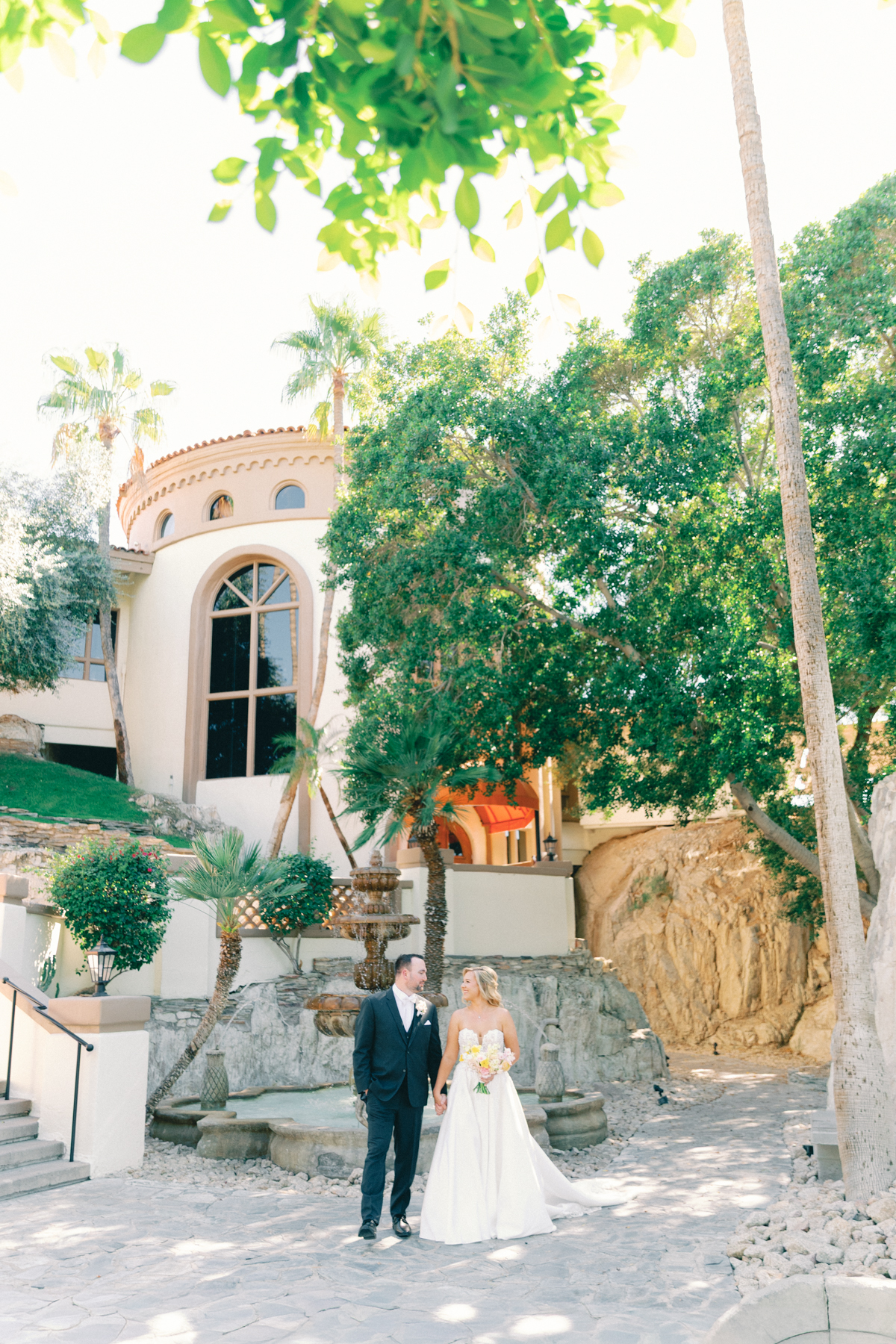Bride and (groom) walking in front of venue