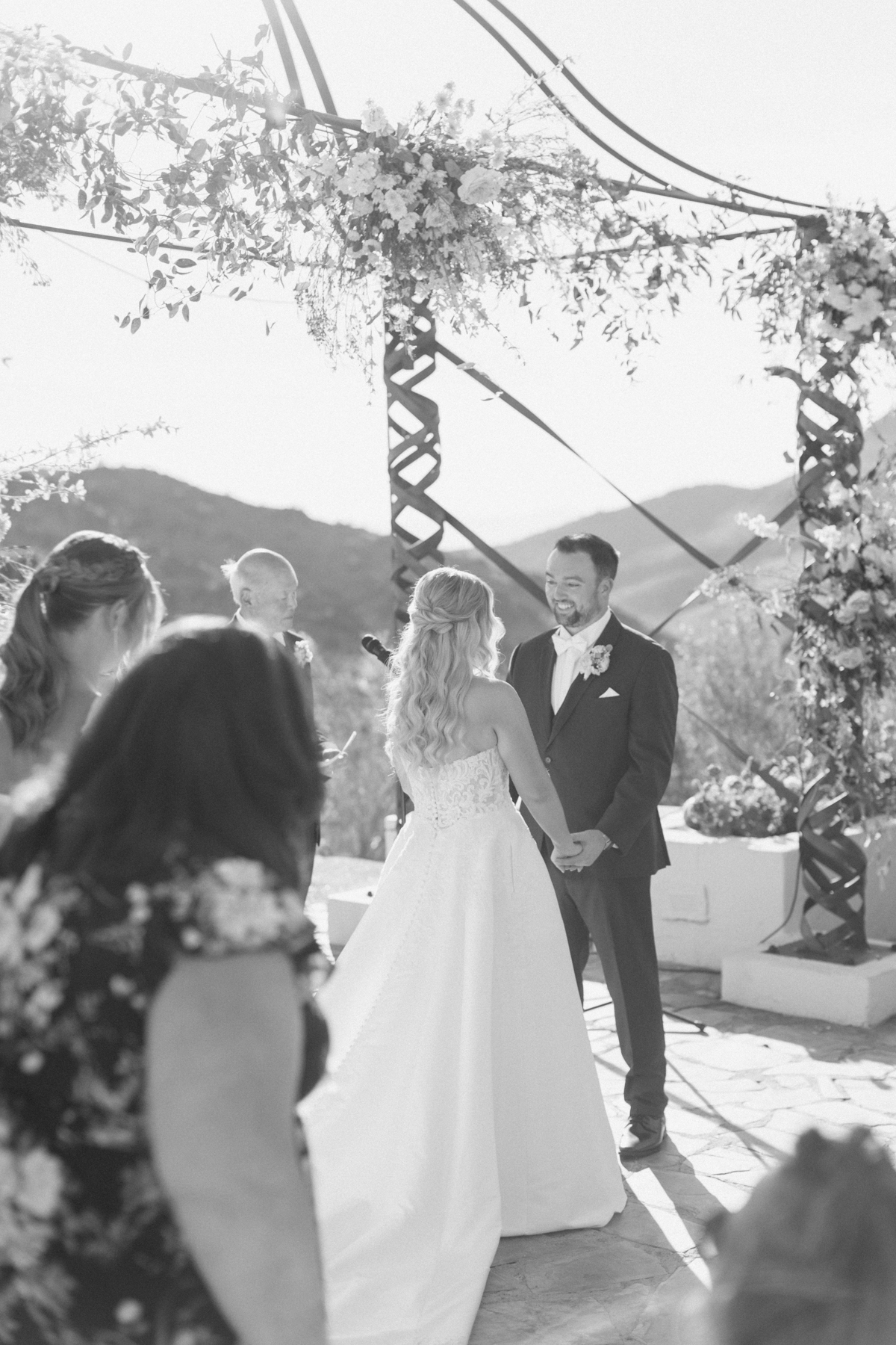 (groom), looking at bride at ceremony