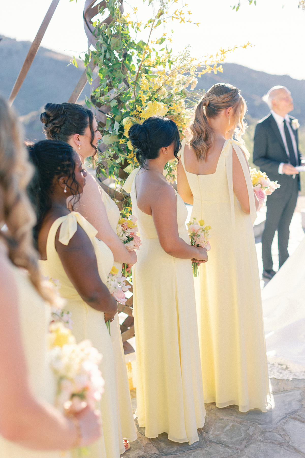Bridesmaids looking at bride at ceremony
