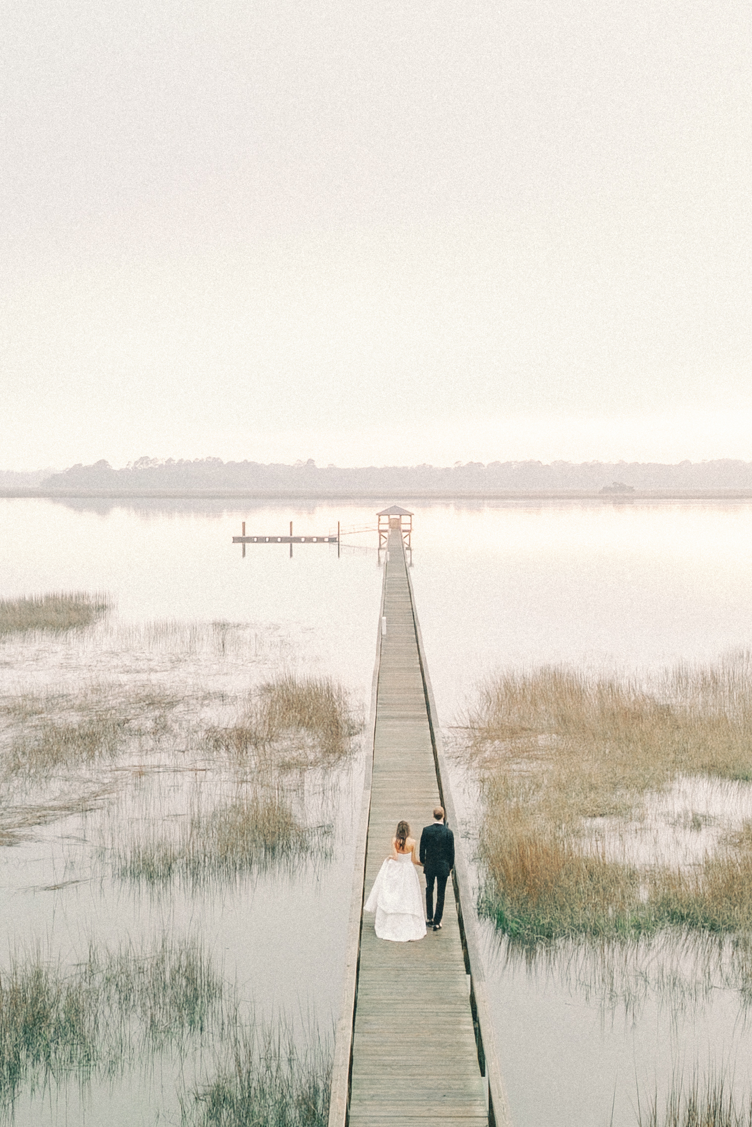 Couple walking on pier