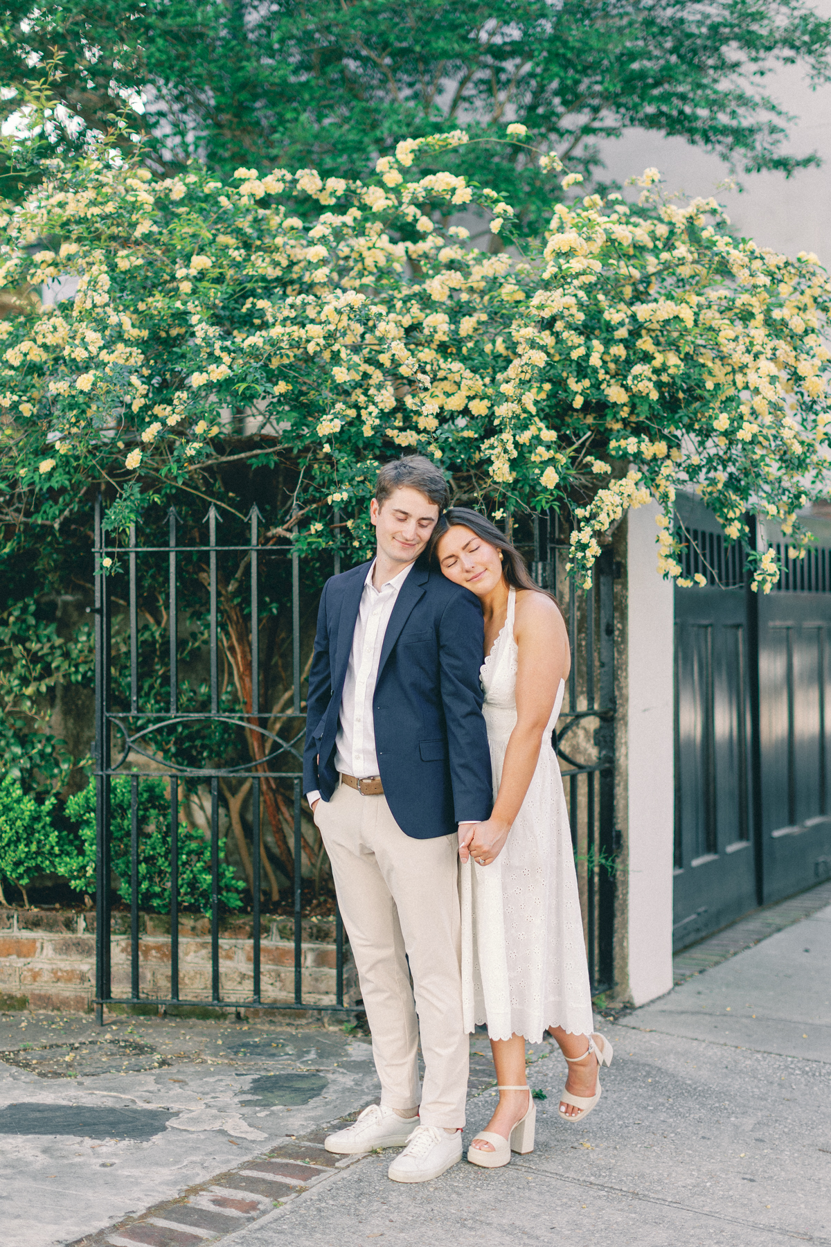 Couple snuggled up by gate