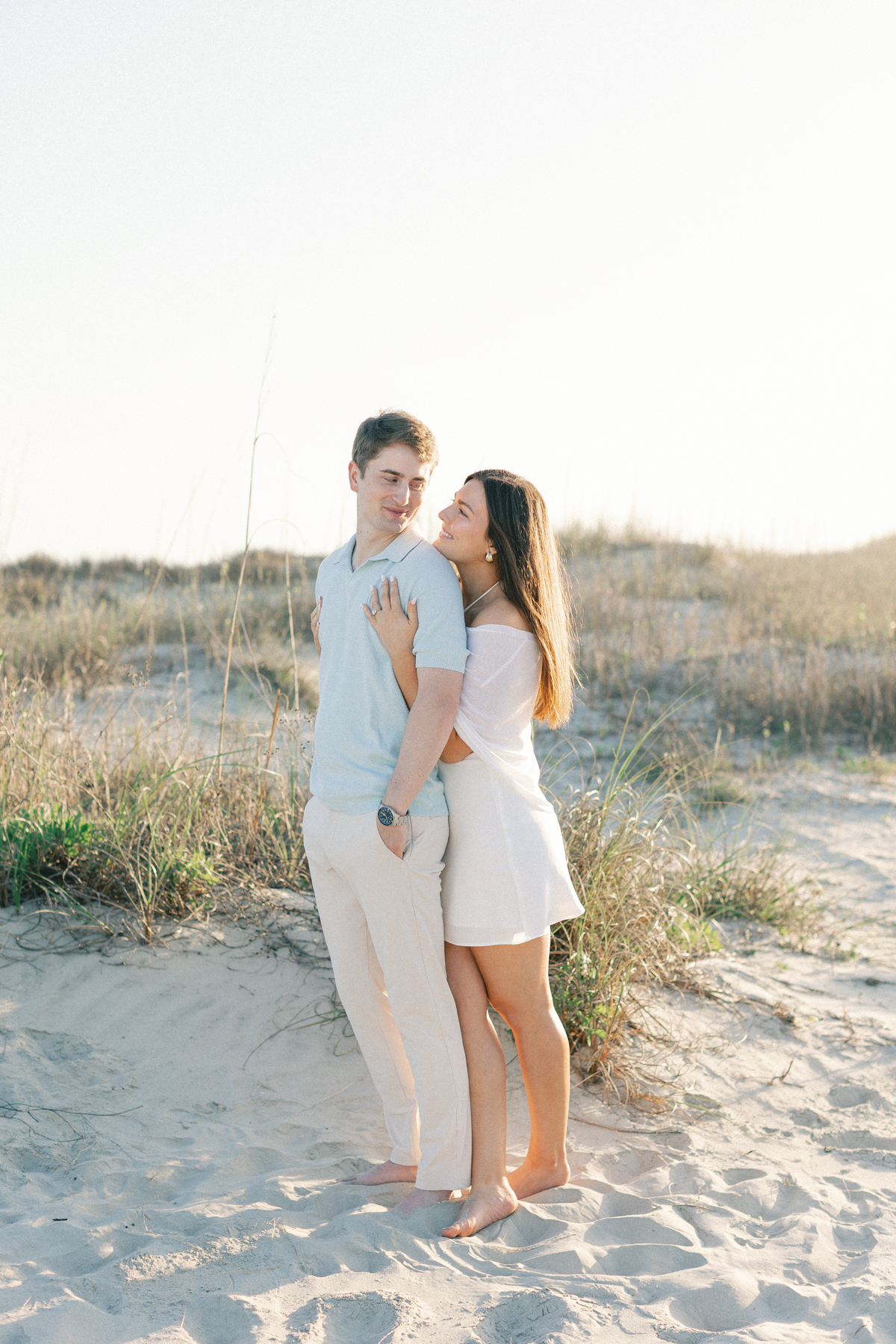 Couple snuggled on beach